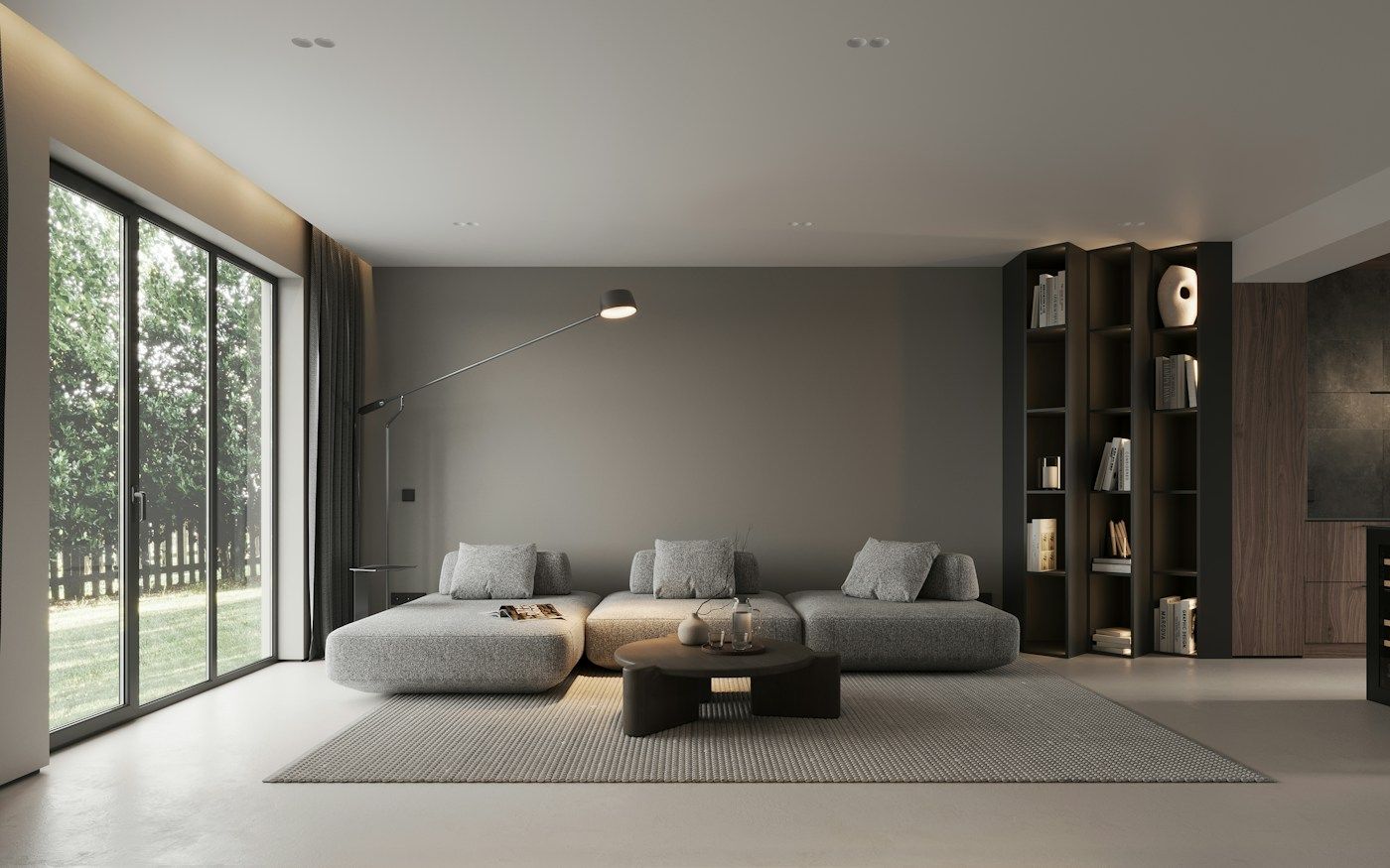 A calm modern living room with a low sofa, timber shelving and a wide glass door to the garden