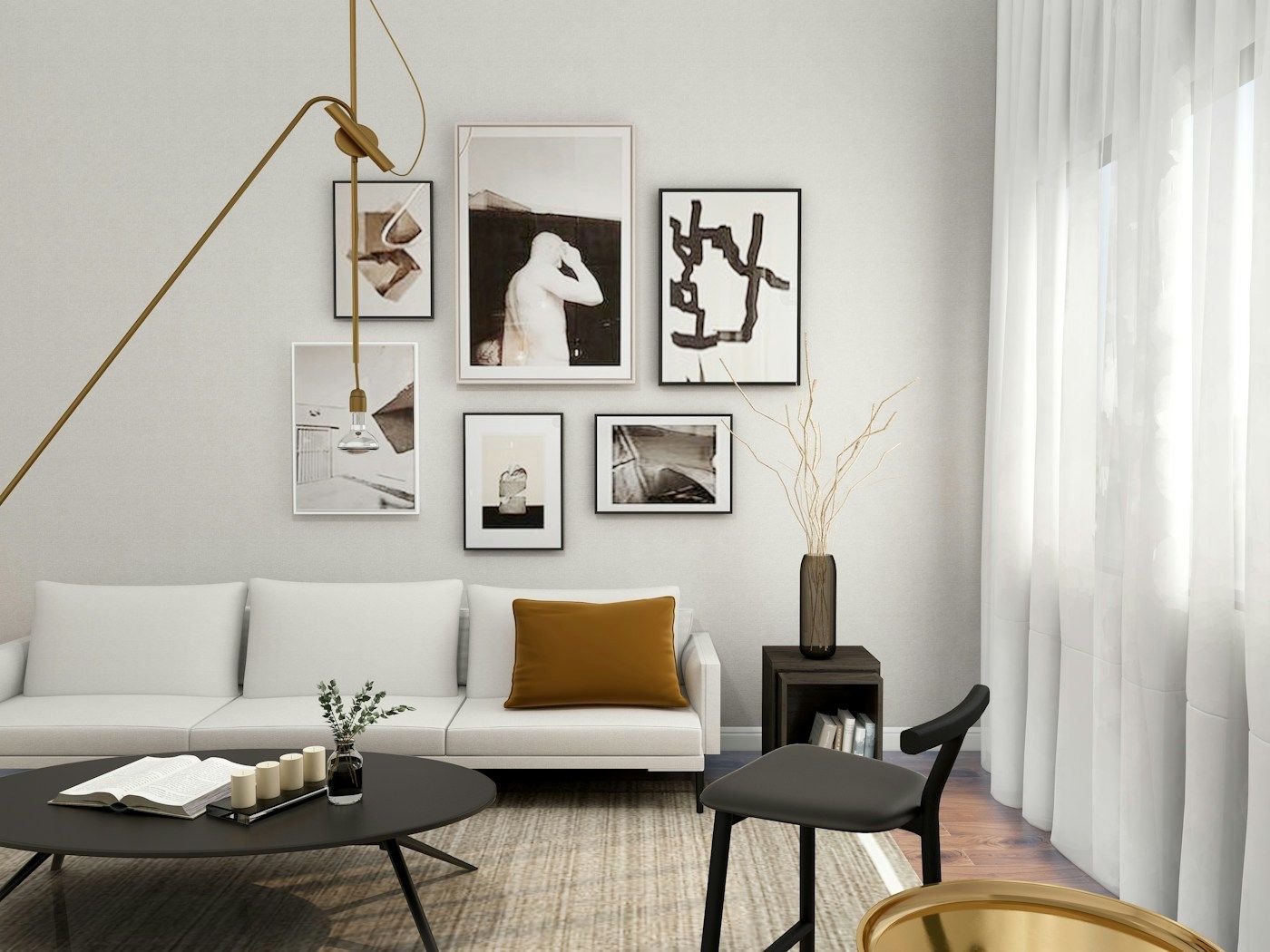 A bright living room with a white sofa, framed art on the wall and sheer curtains